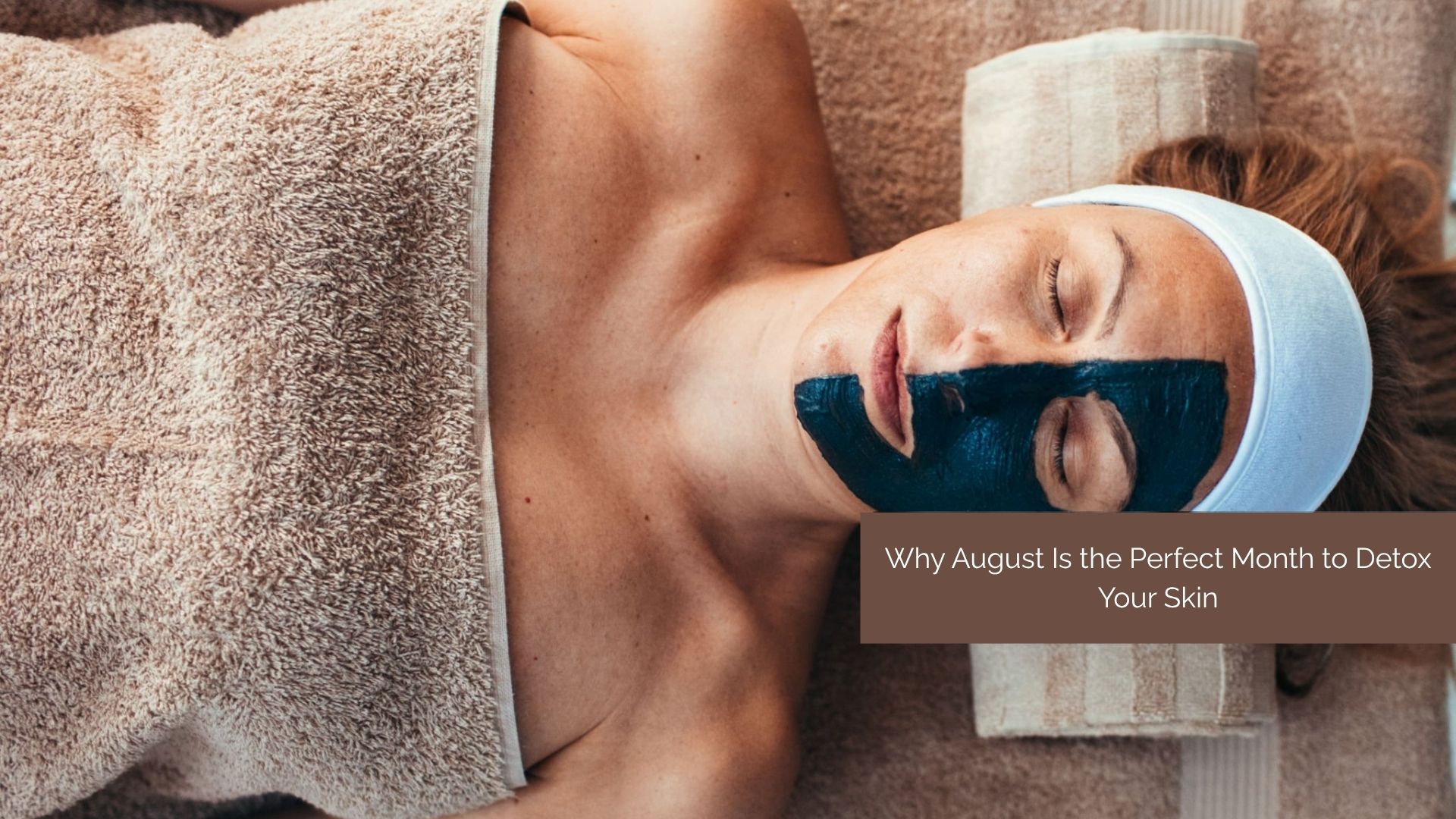 Woman detoxing her skin with a clay mask in August